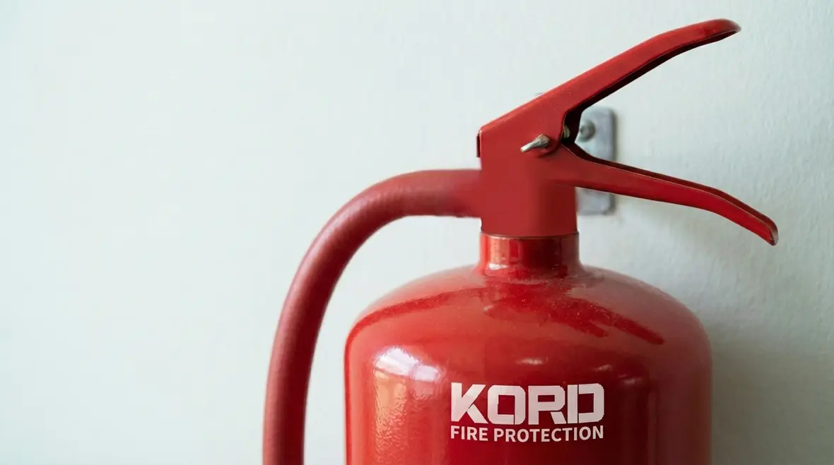 Wall-mounted fire extinguishers in an office hallway