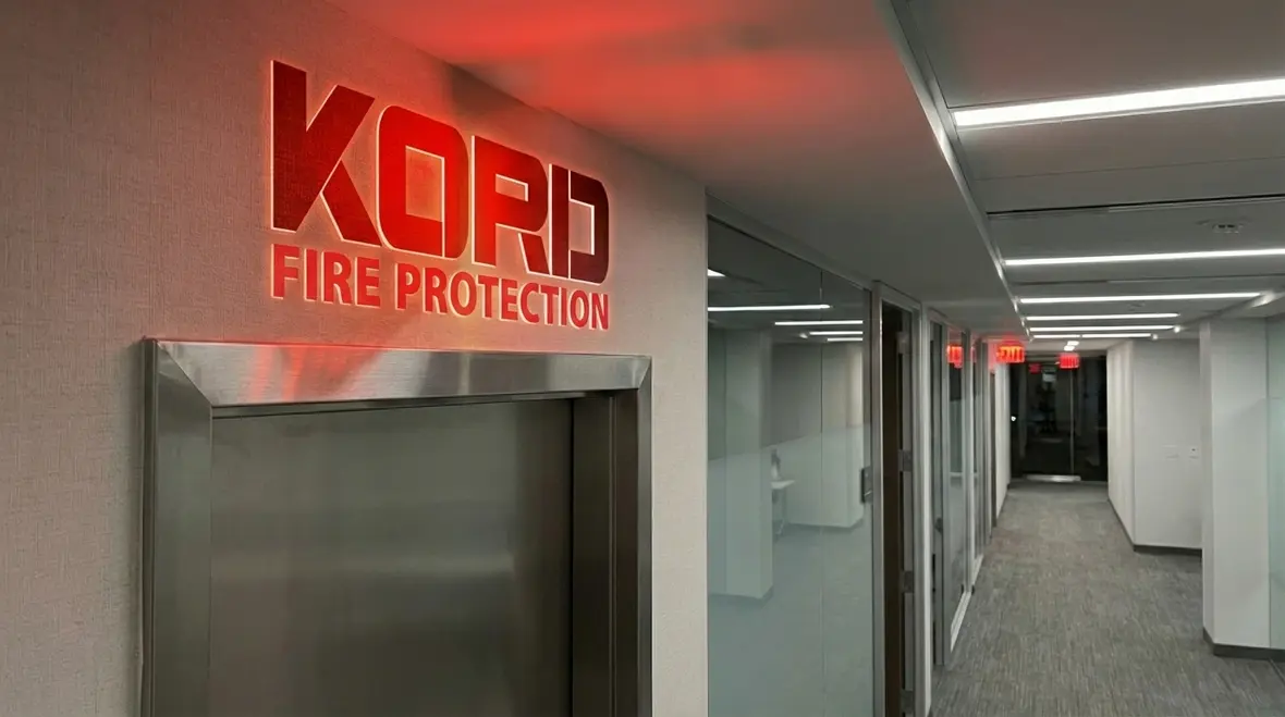 Technician inspecting an exit light that is not working