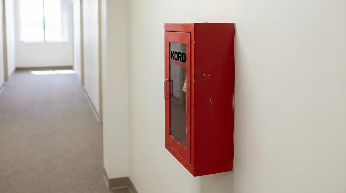 Visible fire extinguisher cabinet with clear signage