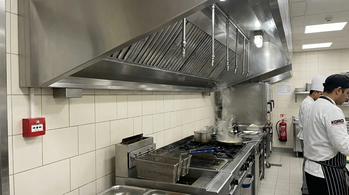 Commercial kitchen fire suppression system over cooking equipment