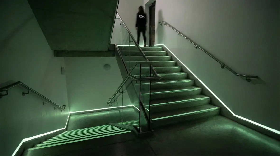 Close-up of photoluminescent stair nosing and handrail markings