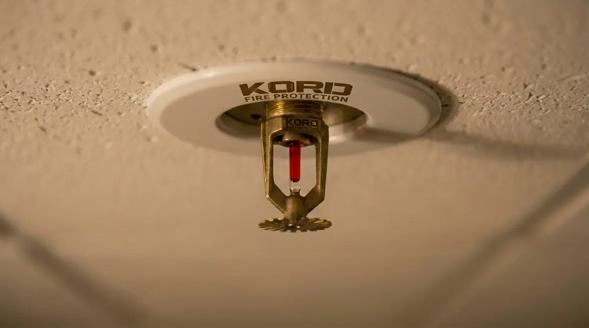 Retractable telescoping sprinkler head concealed in modern ceiling