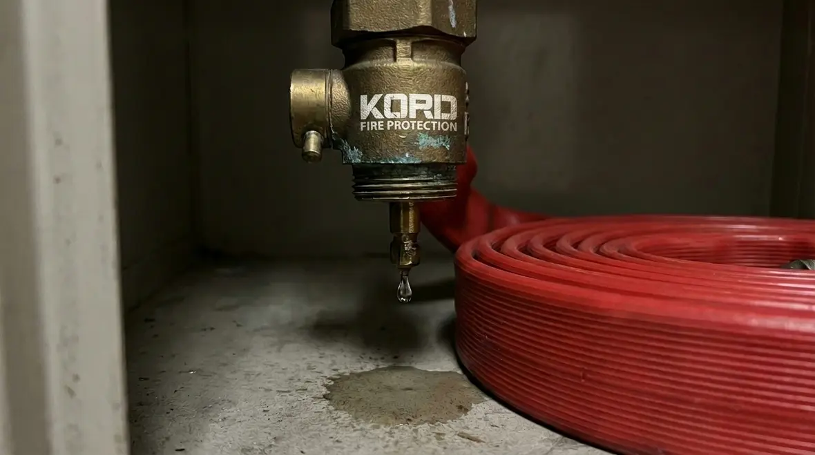 Standpipe hose valve leaking in a stairwell cabinet