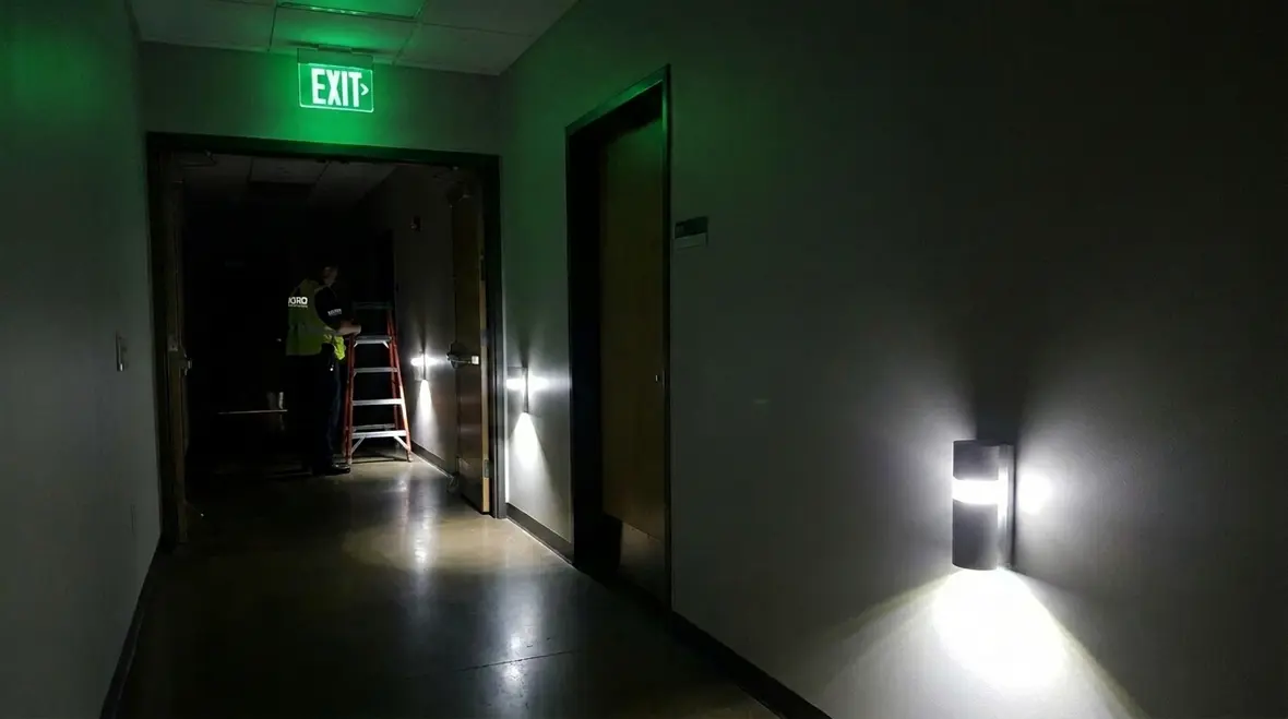 Emergency lighting for exits in a commercial building corridor