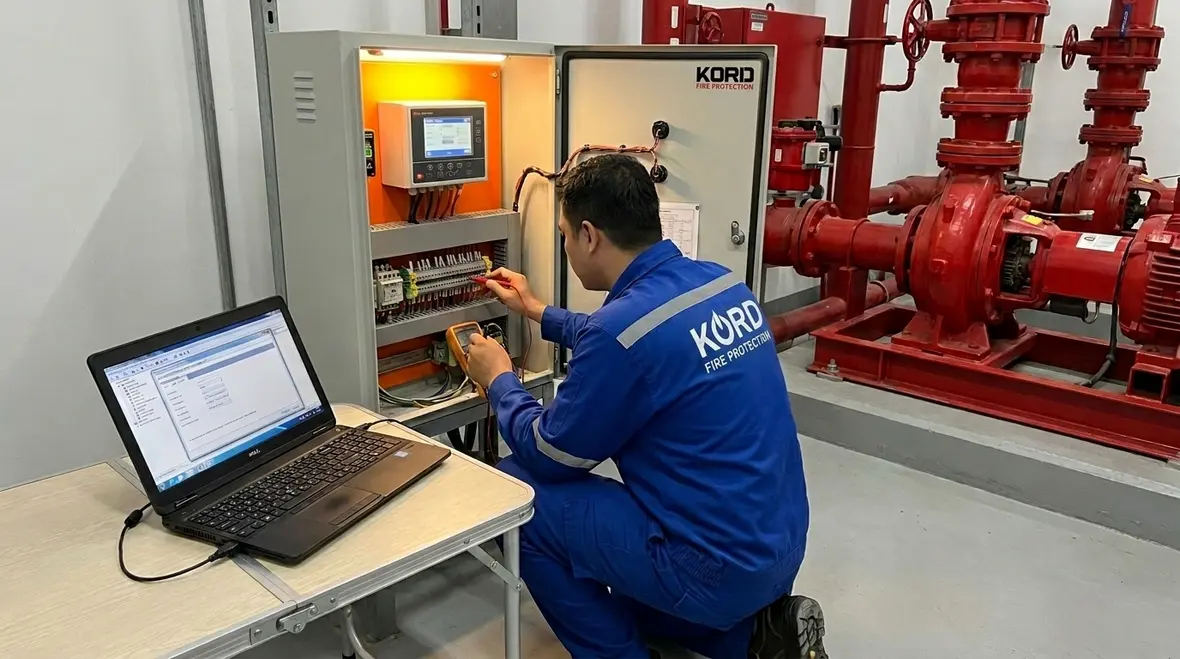 Fire protection technician reviewing fire pump controller diagnostics
