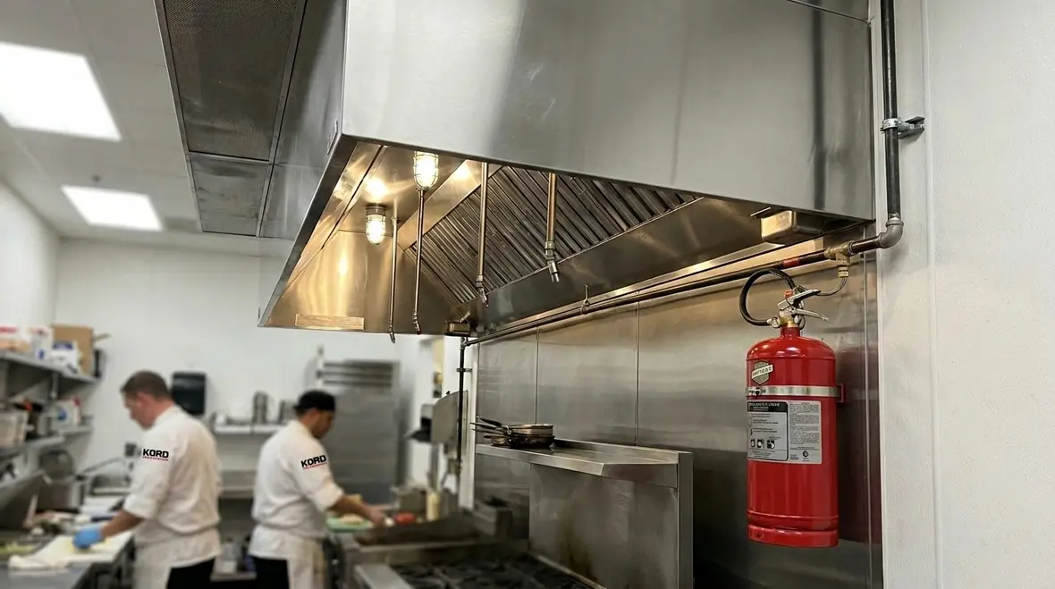 Buckeye Kitchen Mister fire suppression system protecting a commercial kitchen cookline