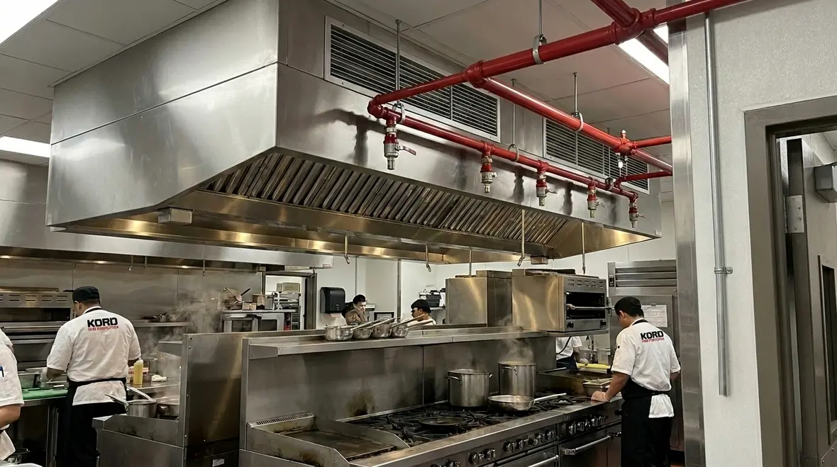 NFPA 17A kitchen suppression system installed over a commercial cooking line