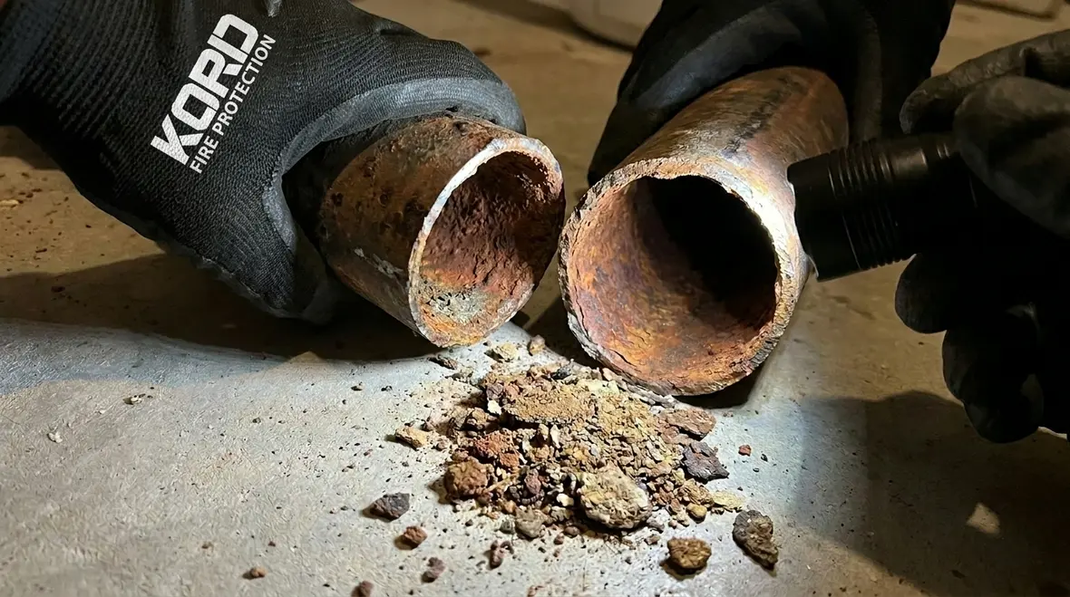 Fire sprinkler pipe corrosion signs inside a commercial fire protection system