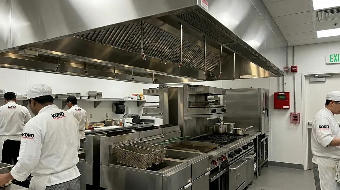 Hospital kitchen fire suppression system protecting a commercial cooking line