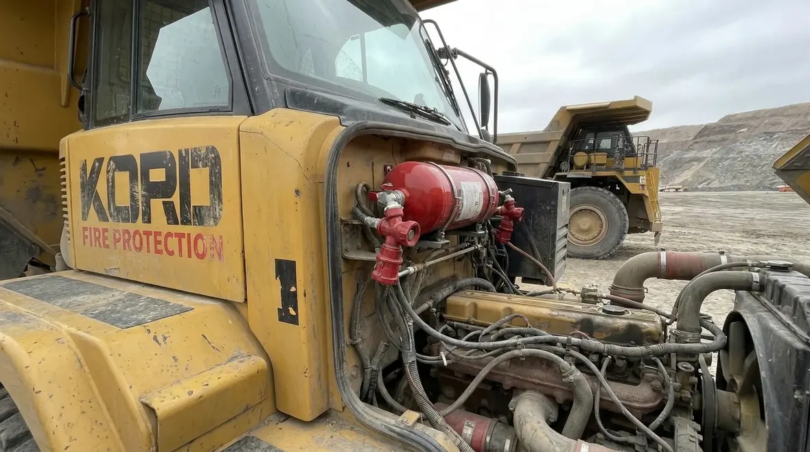 Mining equipment fire suppression system protecting heavy machinery