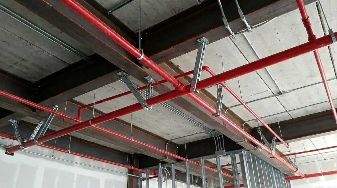 Fire sprinkler system seismic bracing installed overhead in a commercial facility