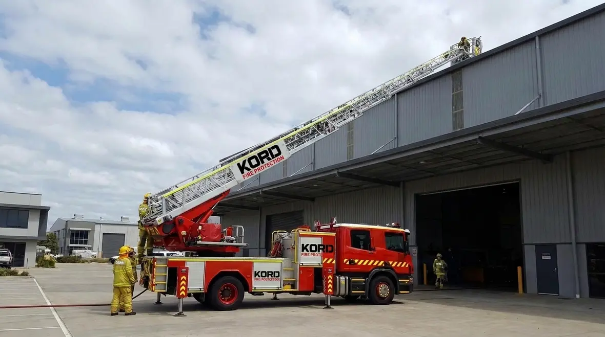 Aerial ladder fire apparatus positioned for elevated access operations