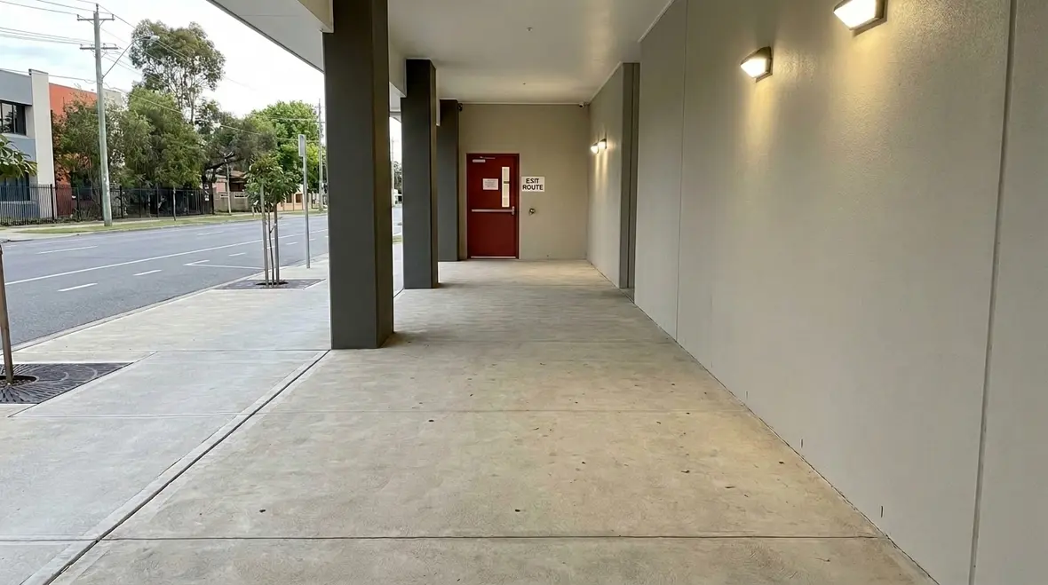 Exit discharge path outside a commercial building showing a clear route to safety