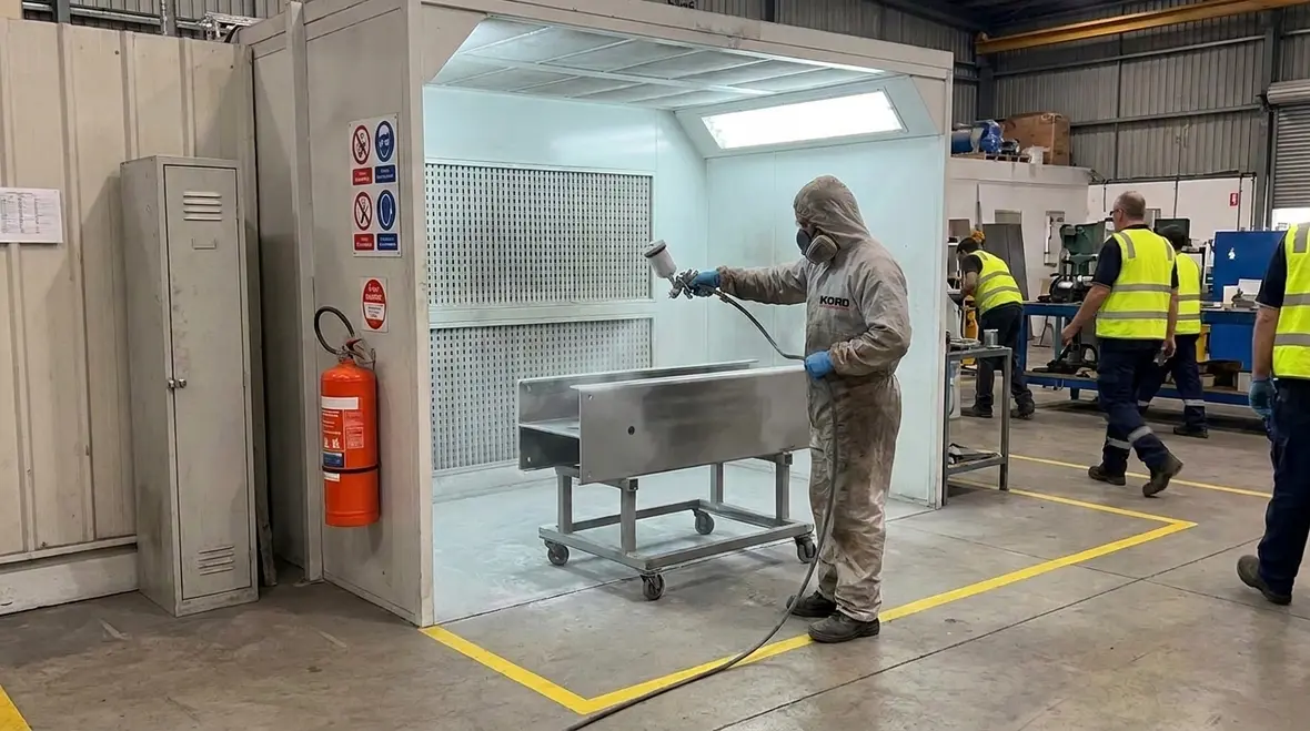 Spray painting fire safety work area with flammable coating application controls
