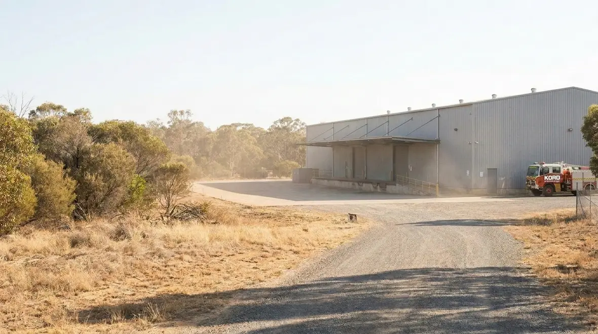Industrial facility near bushland showing wildland fire exposure and defensible space planning